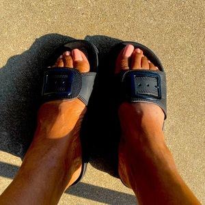 Pool slide plain slip sandal with buckle.